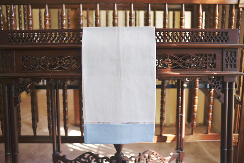 White Hemsitch Guest Towel with Blue Bell borders. 14"x22"